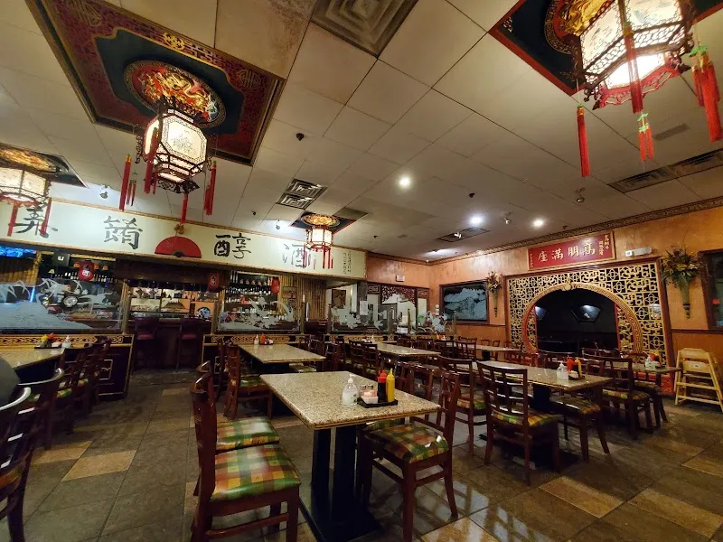 Interior of Lee's Golden Buddha Chinese restaurant with traditional lanterns and ornate decor.